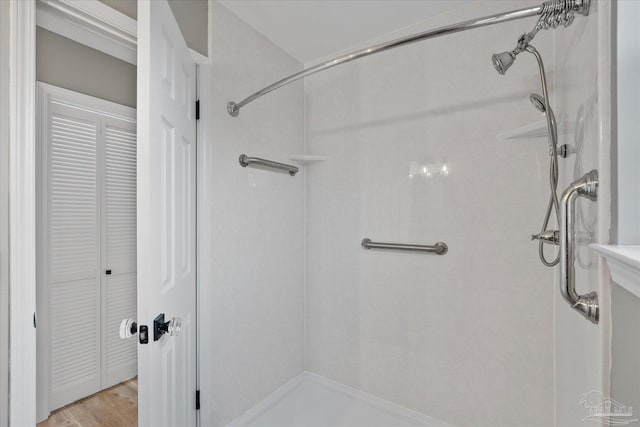 bathroom with a shower and hardwood / wood-style flooring