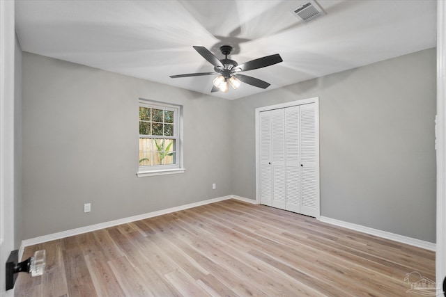 unfurnished bedroom featuring ceiling fan, a closet, and light hardwood / wood-style floors