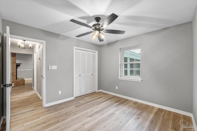 unfurnished bedroom with ceiling fan, a closet, and light hardwood / wood-style floors