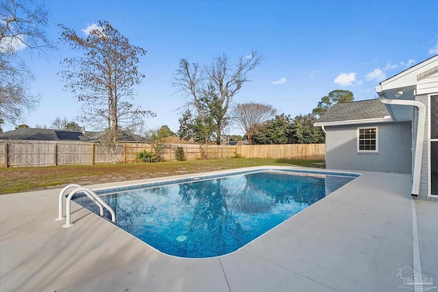 view of pool with a yard and a patio