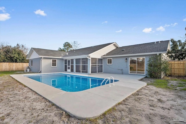 view of pool featuring a patio and a sunroom