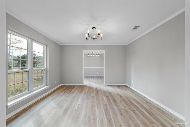 unfurnished room featuring light wood-type flooring, a chandelier, and ornamental molding