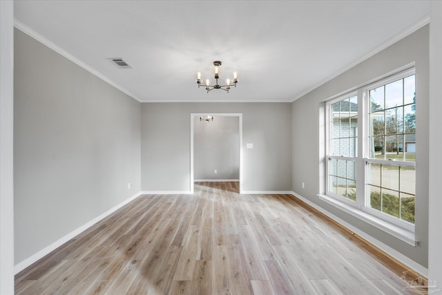 unfurnished room featuring crown molding, light wood-type flooring, and an inviting chandelier