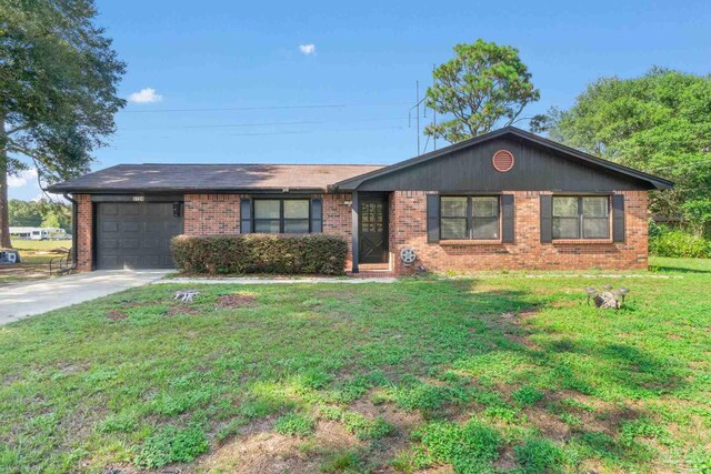 ranch-style home featuring a garage and a front lawn