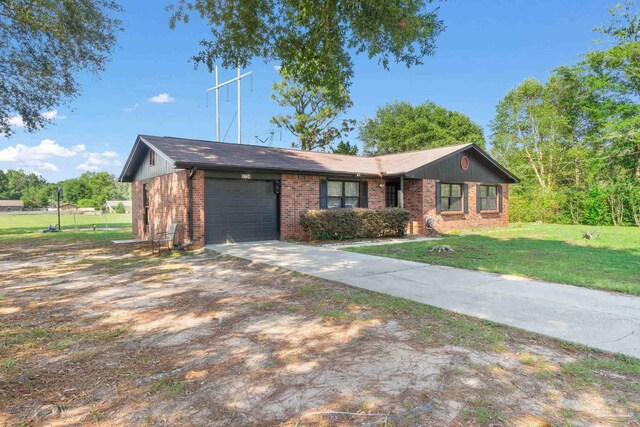 ranch-style house with a garage and a front yard