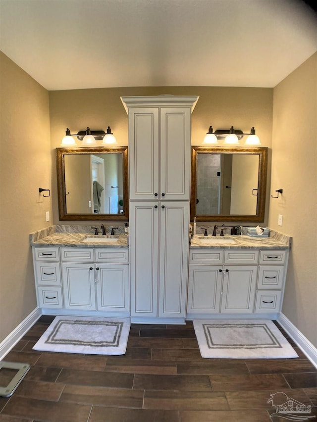 bathroom featuring vanity, wood tiled floor, and baseboards