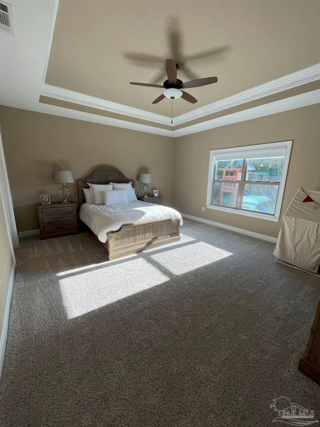 bedroom featuring crown molding, a raised ceiling, carpet flooring, and visible vents