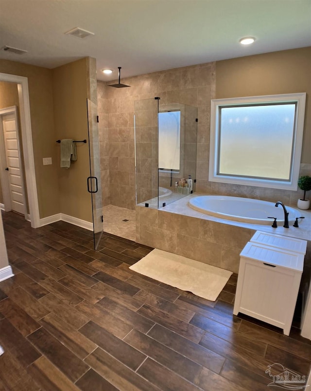 full bathroom with a garden tub, wood finished floors, a stall shower, visible vents, and recessed lighting