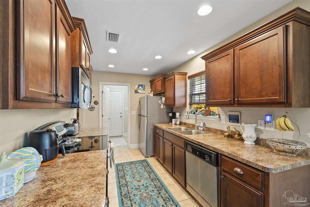 3288 Wasatch Range Loop, Pensacola, FL 32526 - kitchen featuring stainless steel appliances, a sink, light tile patterned floors, recessed lighting, and light countertops
