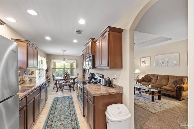 3288 Wasatch Range Loop, Pensacola, FL 32526 - kitchen with stainless steel appliances, arched walkways, recessed lighting, a sink, and pendant lighting