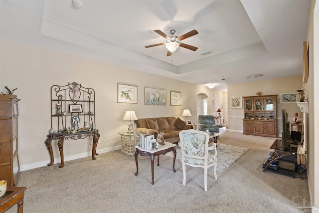 3288 Wasatch Range Loop, Pensacola, FL 32526 - living area with arched walkways, a raised ceiling, a ceiling fan, and carpet flooring