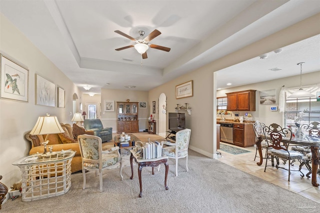3288 Wasatch Range Loop, Pensacola, FL 32526 - living area featuring arched walkways, ceiling fan, a raised ceiling, light tile patterned floors, and light colored carpet