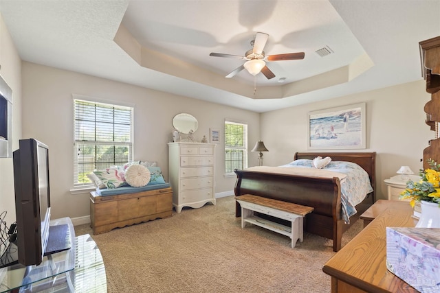 3288 Wasatch Range Loop, Pensacola, FL 32526 - bedroom with a tray ceiling, baseboards, light carpet, and a ceiling fan