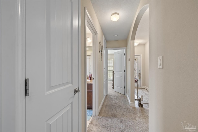 3288 Wasatch Range Loop, Pensacola, FL 32526 - hallway featuring light colored carpet, arched walkways, and baseboards