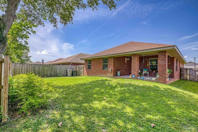 3288 Wasatch Range Loop, Pensacola, FL 32526 - back of house featuring brick siding, a patio, and roof with shingles