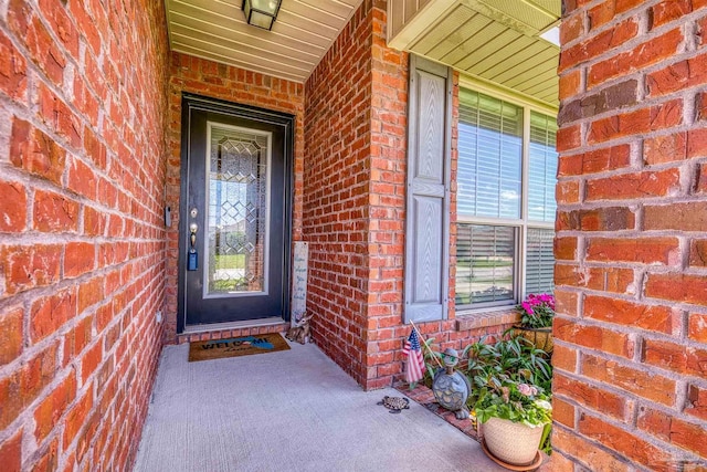3288 Wasatch Range Loop, Pensacola, FL 32526 - doorway to property featuring brick siding and covered porch
