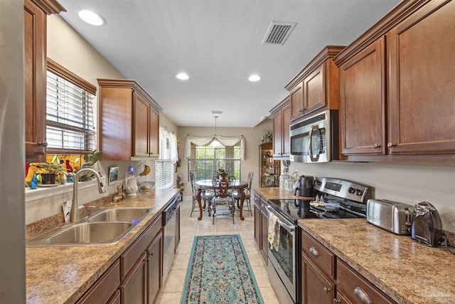 3288 Wasatch Range Loop, Pensacola, FL 32526 - kitchen featuring stainless steel appliances, a sink, light tile patterned floors, recessed lighting, and hanging light fixtures