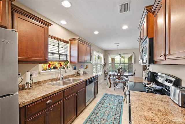3288 Wasatch Range Loop, Pensacola, FL 32526 - kitchen with stainless steel appliances, a sink, recessed lighting, light countertops, and light tile patterned flooring