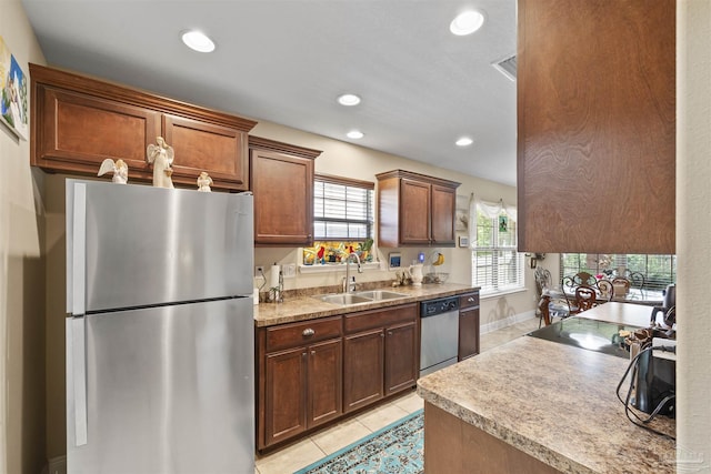 3288 Wasatch Range Loop, Pensacola, FL 32526 - kitchen with stainless steel appliances, a sink, light tile patterned floors, recessed lighting, and light countertops
