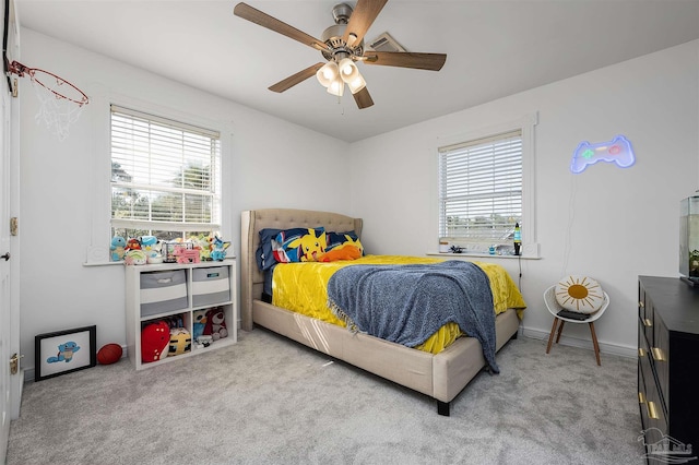 bedroom with light carpet, multiple windows, and ceiling fan