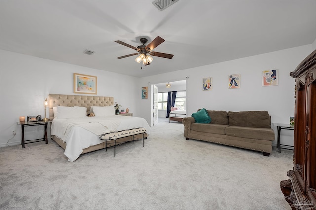 bedroom with light carpet and ceiling fan