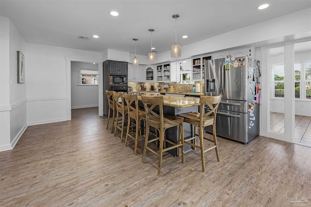 dining room with sink and light wood-type flooring