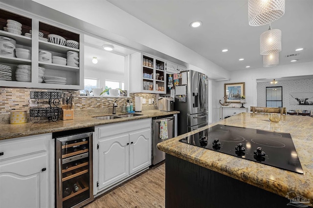 kitchen featuring stainless steel appliances, wine cooler, stone countertops, and white cabinets