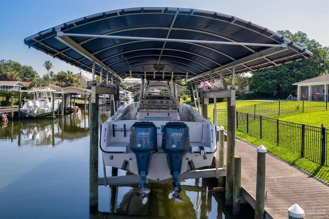 view of dock featuring a water view and a lawn