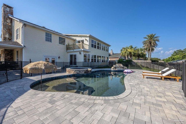 view of pool featuring an in ground hot tub and a patio