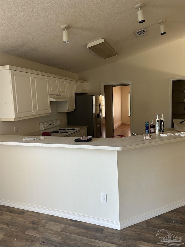 kitchen with stainless steel fridge, vaulted ceiling, dark wood-type flooring, white electric stove, and white cabinets