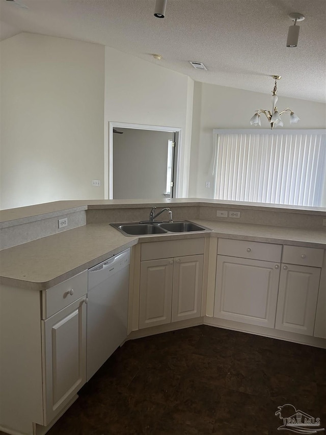 kitchen with white cabinets, sink, an inviting chandelier, dishwasher, and lofted ceiling