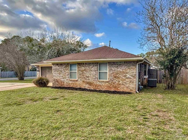 view of home's exterior with an attached garage, fence, cooling unit, and brick siding