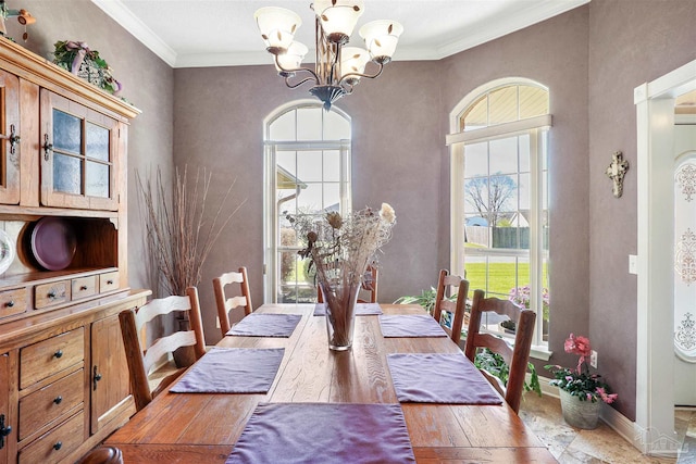 dining space with a chandelier, wood-type flooring, baseboards, and ornamental molding