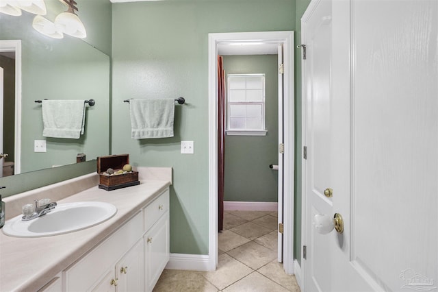 bathroom with tile patterned flooring, vanity, and baseboards