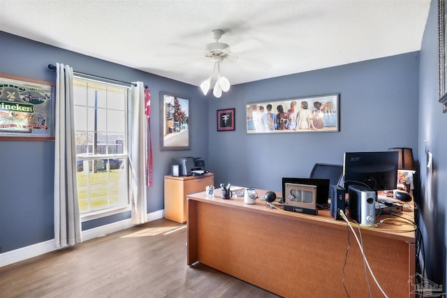 office space with wood finished floors, baseboards, and ceiling fan