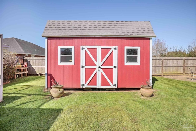 view of shed featuring fence