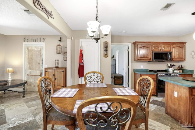 dining space featuring visible vents, an inviting chandelier, and stone finish flooring