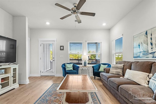 living room featuring light wood-type flooring, baseboards, a ceiling fan, and recessed lighting