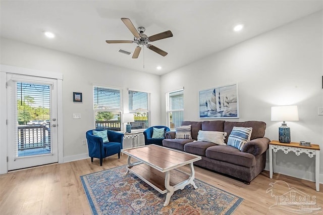 living area featuring light wood-style floors, recessed lighting, a healthy amount of sunlight, and visible vents