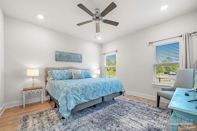 bedroom with light wood-style flooring, baseboards, and recessed lighting