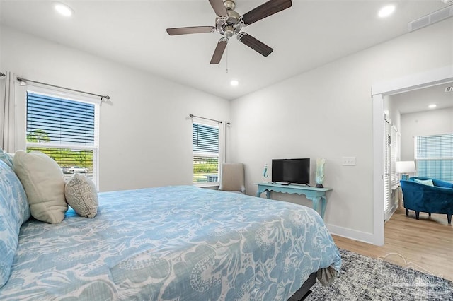 bedroom with ceiling fan, recessed lighting, wood finished floors, visible vents, and baseboards