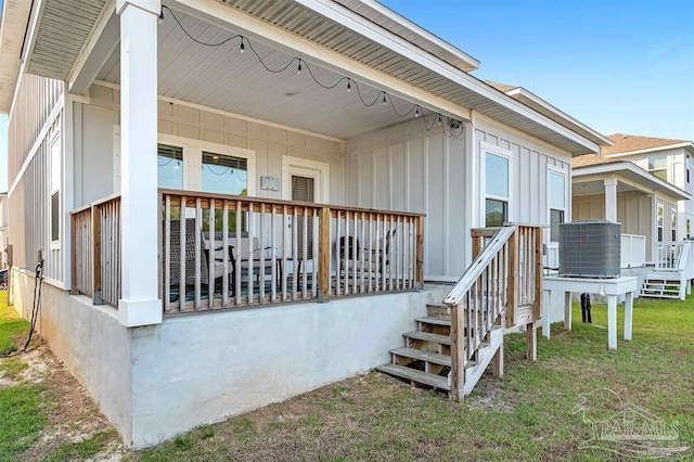 doorway to property featuring central AC and a lawn