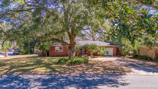 ranch-style house with driveway, brick siding, and an attached garage