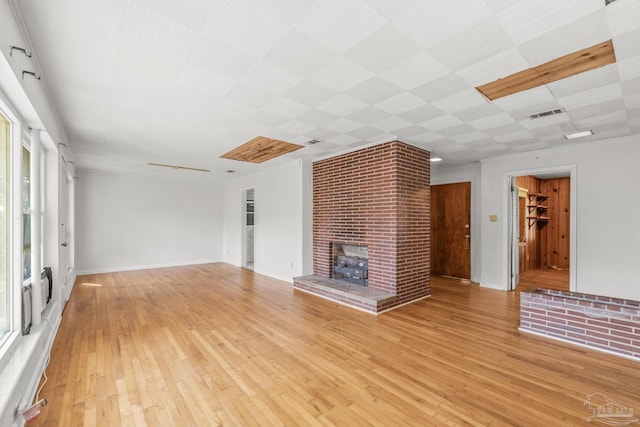 unfurnished living room with light wood-type flooring and visible vents