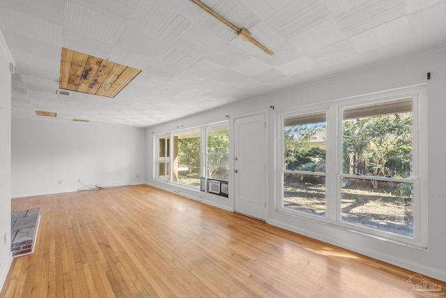 unfurnished living room with light wood-style floors, baseboards, and visible vents