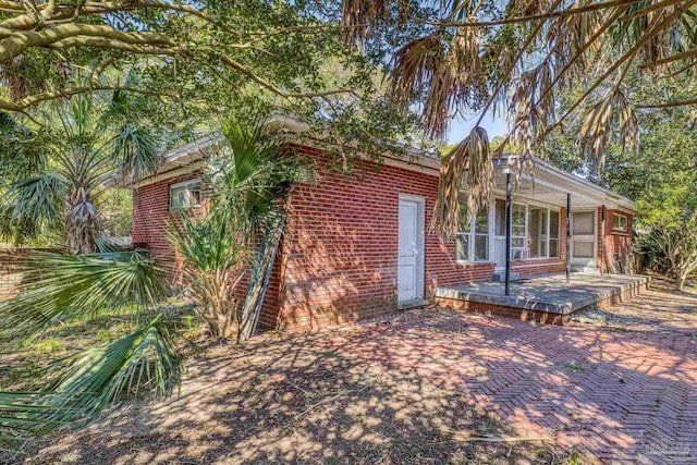 view of side of home with brick siding