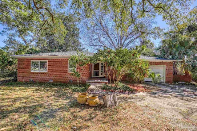 single story home with an attached garage, driveway, and brick siding