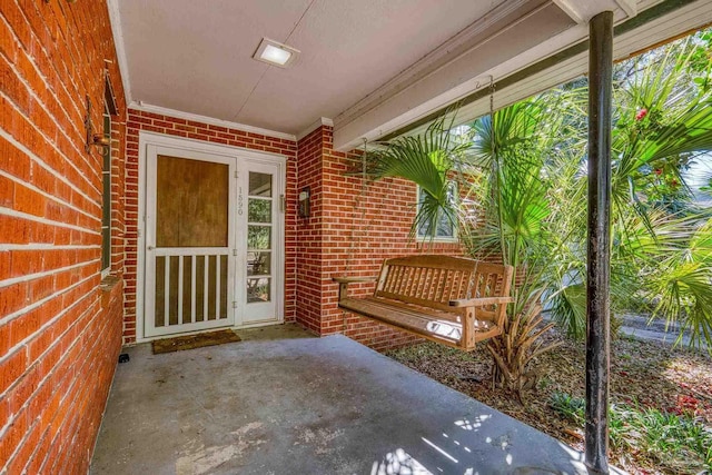 entrance to property with brick siding