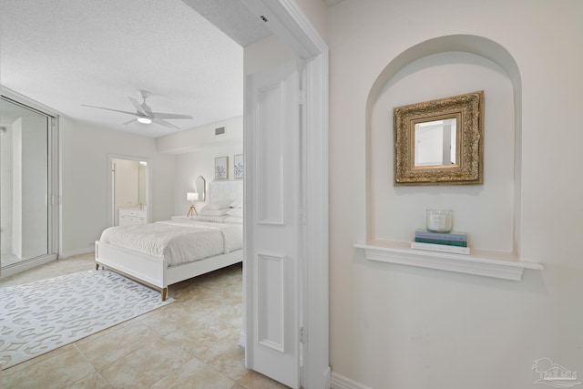 8501 Gulf Blvd Unit 3B, Navarre Beach, FL 32566 - bedroom with light tile patterned flooring, ensuite bath, a ceiling fan, and baseboards