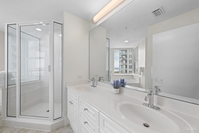 8501 Gulf Blvd Unit 3B, Navarre Beach, FL 32566 - bathroom featuring a shower stall, a textured ceiling, double vanity, and recessed lighting